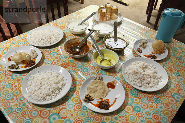 Gedeckter Tisch in einfachem Restaurant  Teller mit Reis und verschiedene Soßen  Kallar  Kerala  Südindien  Indien  Südasien  Asien