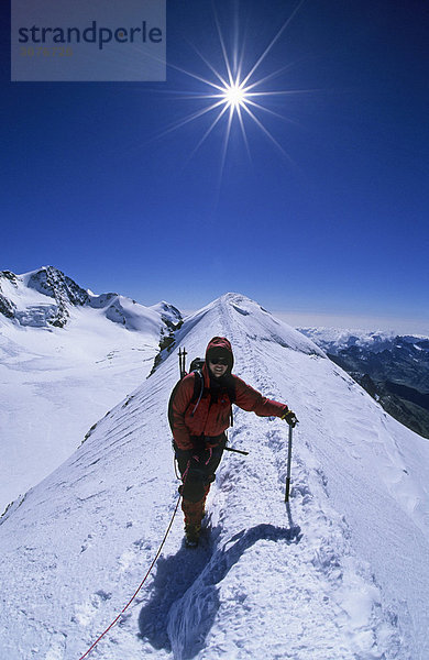 Bergsteigerin auf dem Gipfelgrat des Castor Wallis Italien