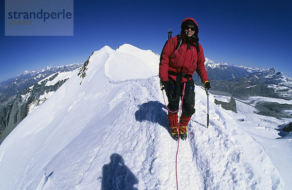 Bergsteigerin auf dem Gipfelgrat des Castor Wallis Italien