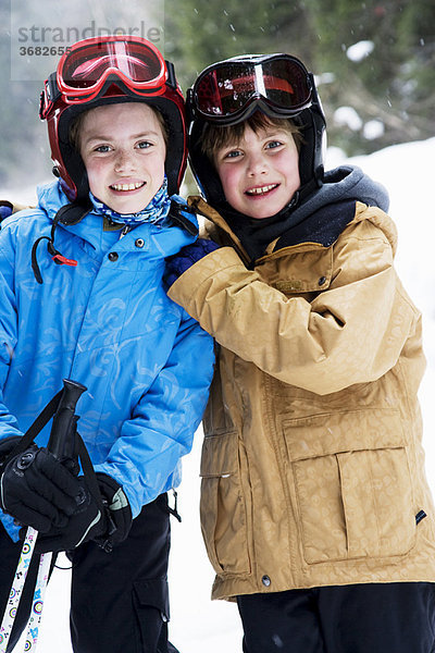 Kinder auf Skiern umarmend