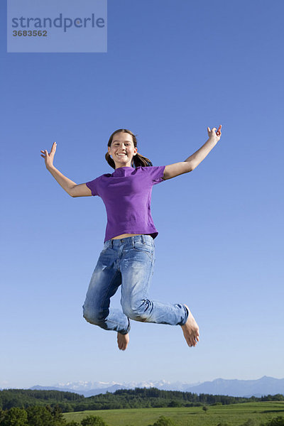 Mädchen springt in der Luft  glücklich