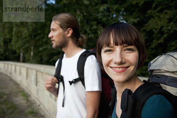 Eine junge Backpackerin mit ihrem Freund  die sich auf die Frau konzentriert.