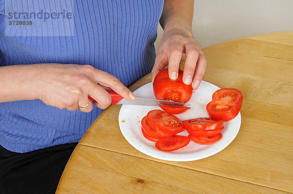 Schneiden einer Tomate in Scheiben