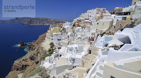 Blick auf den Ort Oia  Ia  mit typischer verschachtelter Kykladenarchitektur  hinten blaues Meer  Santorin  Kykladen  Griechenland  Europa