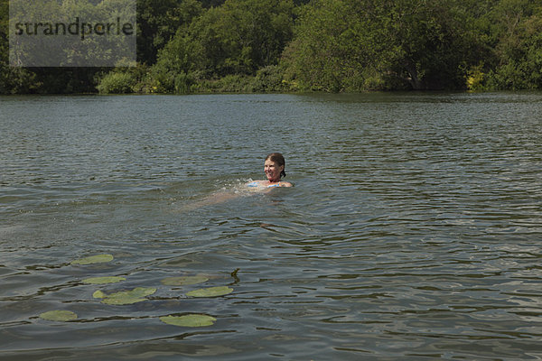 Frau schwimmt im Fluss