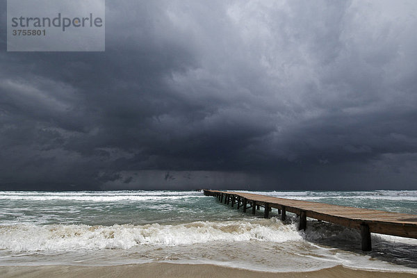 Pier in the Mediterranean Sea  dark storm clouds  Muro  Majorca  Spain  Europe