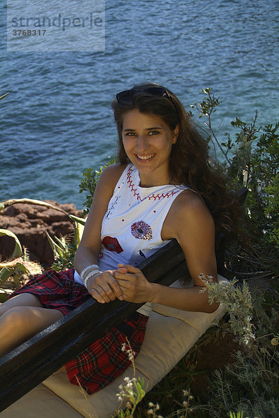 Young woman sitting on bench  EstÈrel Range on the Mediterranean  ThÈoule-sur-Mer  France  Europe