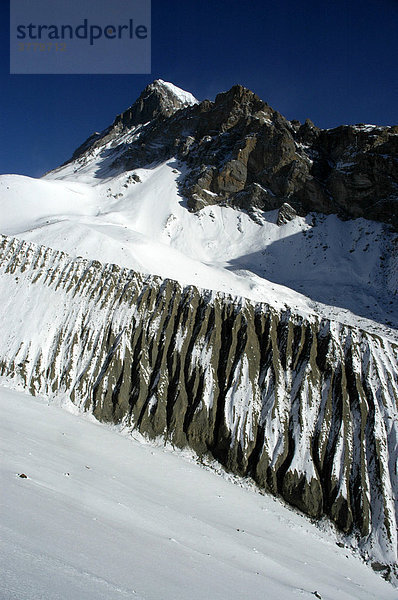 Band eigenartiger Erosion im verschneiten Hochgebirge Thorung La Pass Annapurna Region Nepal