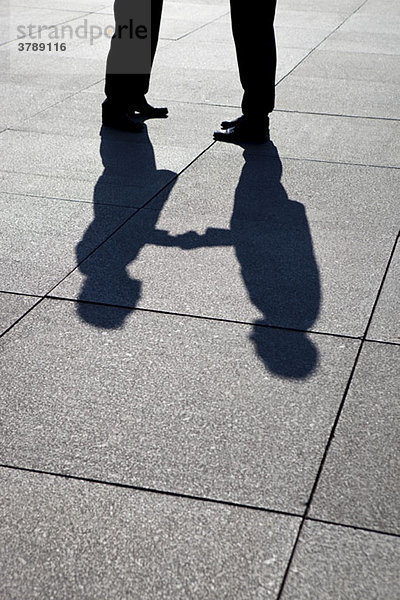 Der Schatten zweier Geschäftsleute beim Händeschütteln  Fokus auf Schatten