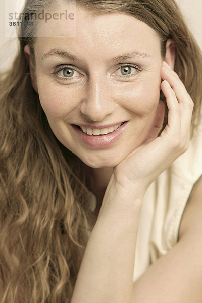 Lächelnde Frau mit langem brünetten Haar