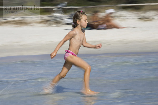 Child running in water  Cala Brandinchi  Sardinia