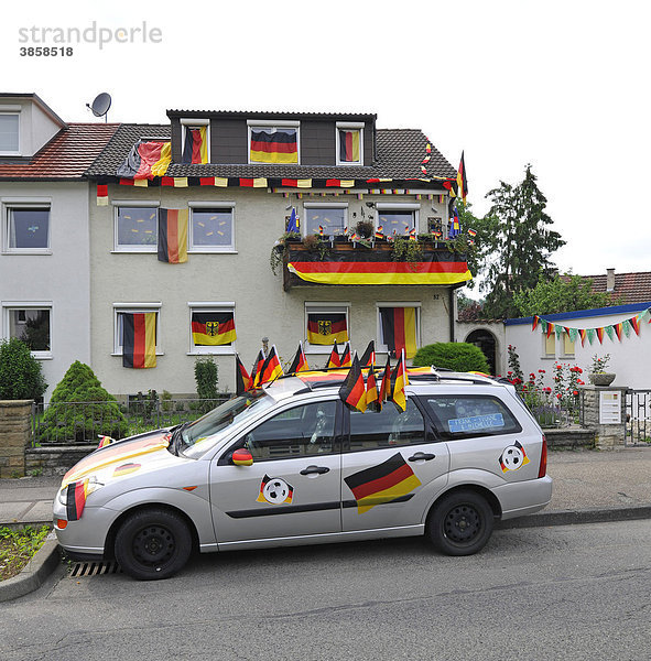 Mit deutschen Flaggen geschmücktes Wohnhaus und Auto während Fußball WM 2010  Stuttgart  Baden-Württemberg  Deutschland  Europa