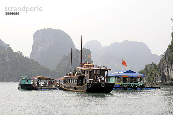 Touristenschiff ankert vor schwimmender Fischzucht  Halong Bucht  Vinh Ha Long  Nordvietnam  Vietnam  Südostasien  Asien