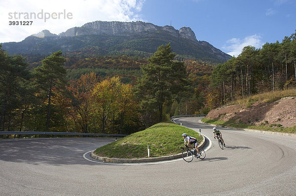 Rennrad-Fahrerin und Fahrer in Kehre am Mendel-Pass oberhalb von Kalteren  Südtirol  Italien  Europa