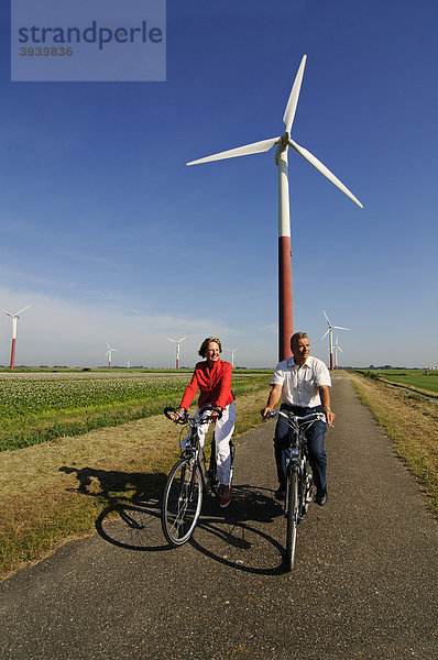 Radfahrer vor Windkraftanlagen  Sexbierum  Friesland  Holland  Niederlande  Europa