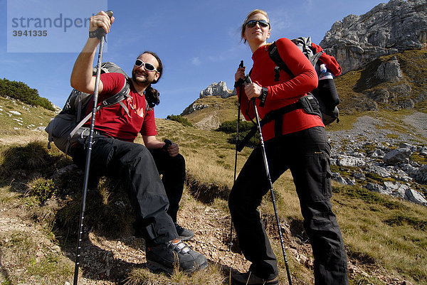 Wanderer  Frau und Mann  Tourenrucksack und Trekkingstöcke  rasten beim Aufstieg zur Heidachstellwand  2192m  Rofan  Achensee  Tirol  Österreich  Europa