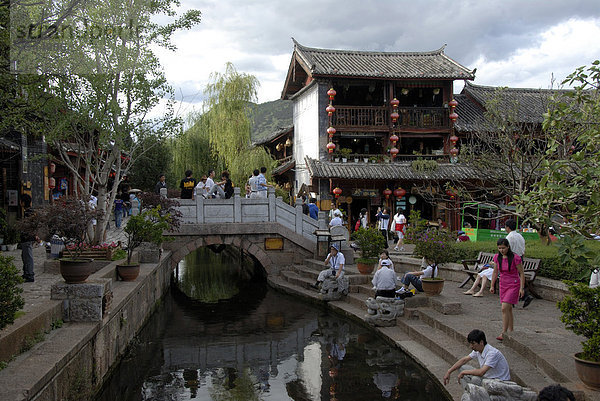 Viele Menschen an Kanal und Brücke  malerische Altstadt  alter Marktplatz  Lijiang  UNESCO Weltkulturerbe  Provinz Yunnan  Volksrepublik China  Asien