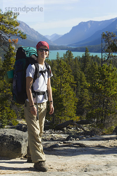 Junge Wanderin  Rucksacktourist  historischer Chilkoot Pass  Chilkoot Trail Wanderweg  dahinter der Lake Bennett See  Yukon Territory  British Columbia  BC  Kanada
