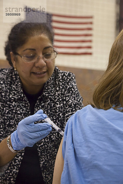 Eine Angestellte im Gesundheitsdienst impft einen Bewohner der Gegend von Detroit gegen den H1N1 Schweinegrippe Virus  Hamtramck  Michigan  USA