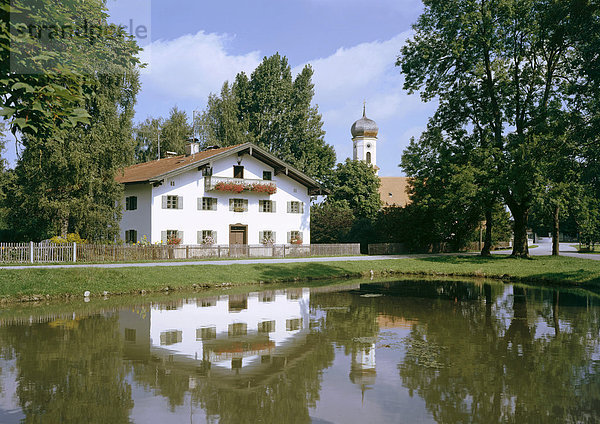 Filialkirche St. Korbinian über dem Dorfweiher neben dem Schlichtinghof  Oberlaindern  Oberbayern  Bayern  Deutschland  Europa
