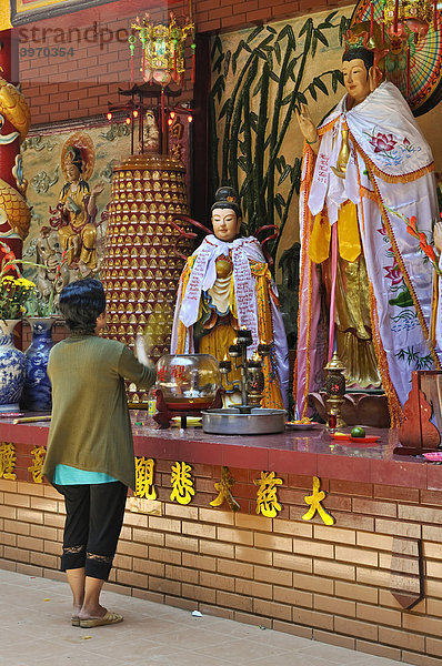 Frau betet stehend vor einem Altar mit Buddha  Quan Am Pagode  Ho Chi Minh Stadt  Saigon  Vietnam  Südostasien