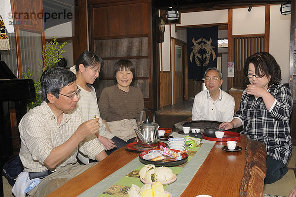 Japanische Familie trinkt Tee in einem traditionellem Wohnzimmer in einem japanischen Wohnhaus  Sagara  Präfektur Shizuoka  Japan  Asien