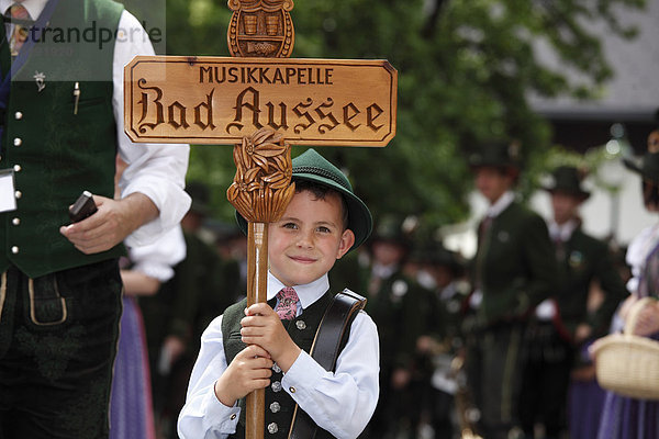 Junge in Tracht hält Holzschild Musikkapelle Bad Aussee  Narzissenfest in Bad Aussee  Ausseer Land  Salzkammergut  Steiermark  Österreich  Europa