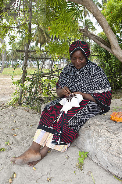 Eine alte Frau stickt ein Muster  Jambiani  Sansibar  Tansania  Afrika