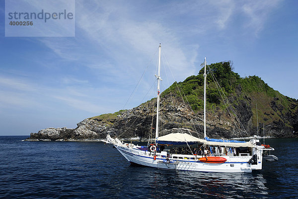 Motorsegler  Tauchschiff vor Insel  Felsenküste  Similan Inseln  Andamanen See  Indischer Ozean  Phuket  Thailand  Asien
