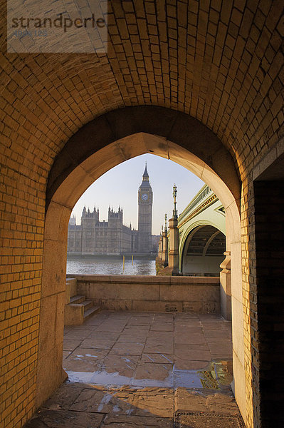 Blick durch einen Bogen unter der Westminster Bridge Brücke auf die Houses of Parliament Parlamentsgebäude  London  England  Großbritannien  Europa