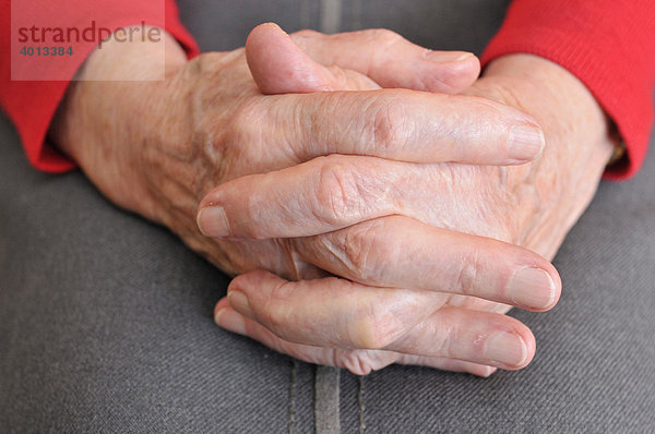 Gefaltete Hände einer Seniorin