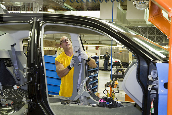 Mitglied der United Auto Workers Union  Gewerkschaft der Automobilindustrie  montieren den Chrysler Sebring Sedan im Chrysler Montagewerk  hier installiert ein Arbeiter eine Sicherheitsgurt-Einheit  Sterling Heights  Michigan  USA