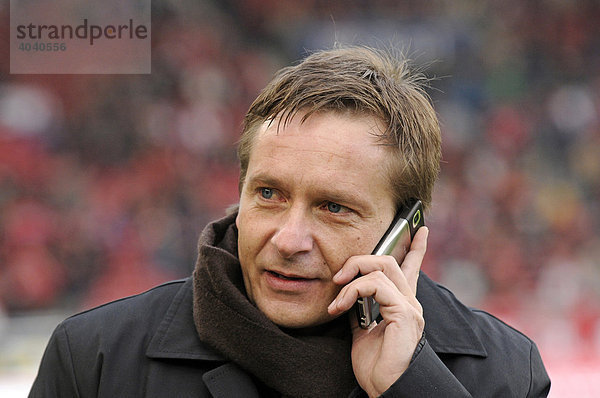 Horst Heldt  manager VfB Stuttgart  on the mobile phone