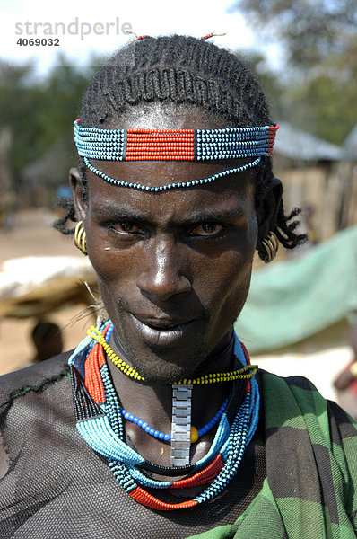 Portrait  Mann mit Stirnband und bunter Halskette  Markt von Dimeka  Äthiopien  Afrika