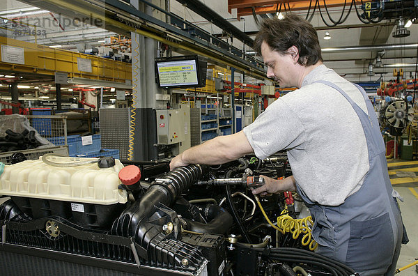 Arbeiter bei Arbeiten an Motor und Getriebe für Lkw  Fertigung  Produktion MAN Nutzfahrzeuge AG  München  Bayern  Deutschland  Europa