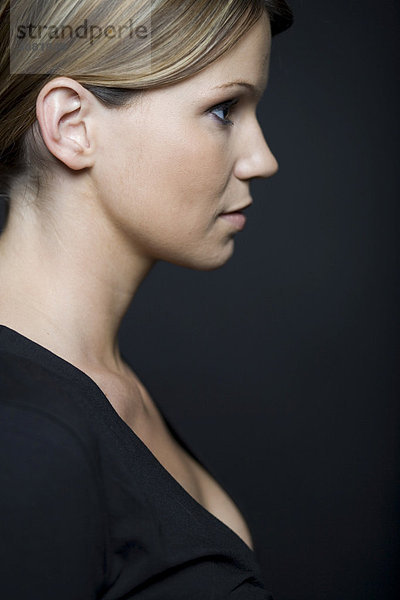 Kopf einer Frau im Profil vor Schwarz
