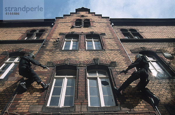 DEU  Deutschland: SEK-Polizisten seilen sich fuer einen Zugriff in eine Wohnung ab.Spezialeinsatzkommando  SEK. Wird zur Verhaftung gefaehrlicher Taeter eingesetzt. Bei Geiselbefreiungen aus Banken  Haeusern  Bussen  Zuegen  Flugzeugen  Schiffen  Fahrzeugen aller Art. Sie verhaften Erpresser  Drogenhaendler  Straftaeter aus dem Bereich der organisierten Kriminalitaet. Sie ueberwaeltigen bewaffnete  gewaltbereite Personen bei Bedrohungslagen. Sie haben eine besondere Ausbildung und umfangreiche Ausruestung und Bewaffnung.