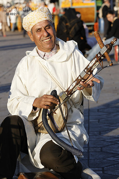 Berber Musiker spielt traditionelle arabische Laute  Djemaa el-Fna  Marrakesch  Marokko  Afrika