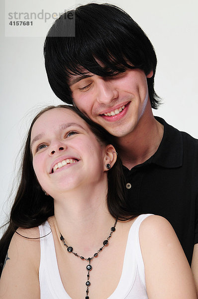 Junges  schwarzhaariges Paar umarmt sich  lächelnd  Portrait