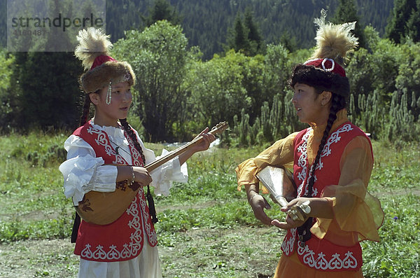 Mädchen in nationaler Tracht mit nationalen Musikinstrumenten. Kasachstan