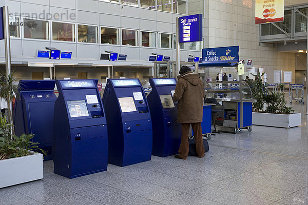 Flughafen Frankfurt  Terminal 2  Kunde zieht Ticket an Ticketautomat  Check In Schalter  Frankfurt  Hessen  Deutschland