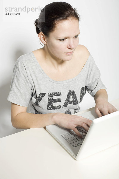 Junge Frau arbeitet an einem Laptop