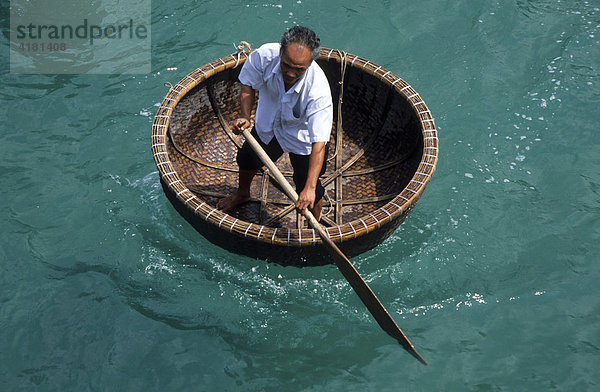 Mann rudert in Rundboot  Vietnam  Asien