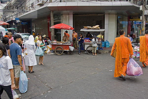 Strassenbild in Bangkok mit zwei Glaubensrichtungen (katholischer Schwester (links) und buddhistischen Mönchen (rechts)  Thailand  Asien