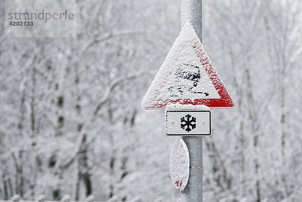 Snow covered sign slippery road Germany