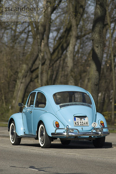 VW Beetle in light blue parked - please efface number before publishing