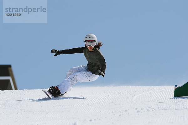 Woman with Arms Outstretched Snowboarden