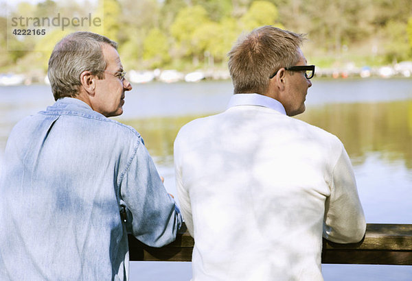 Zwei Männer auf der Brücke mit Blick auf das Wasser