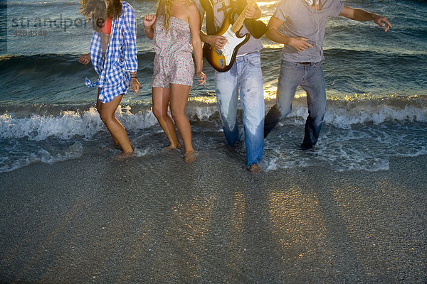 Gruppentanz mit Gitarre bei Strandflut