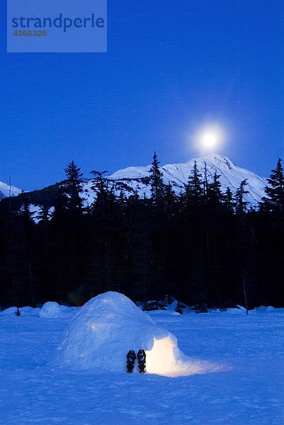 Hand gebaut Iglu in Moonlight beleuchtet mit Schneeschuhen am Eingang Gletscher Tal Girdwood Alaska